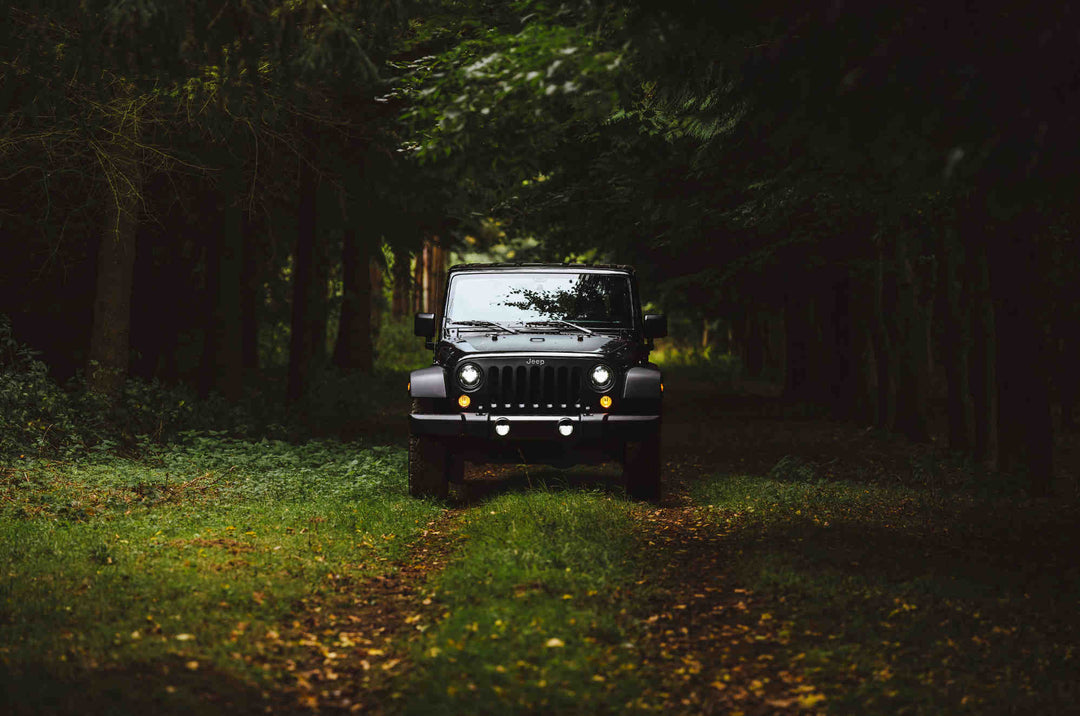 Black Jeep on a forest trail, perfect for jeep decal ideas.