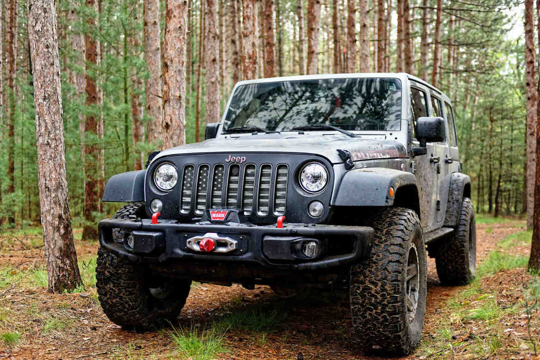 Mud-splattered Jeep on a forest trail, great for jeep name decals inspiration.